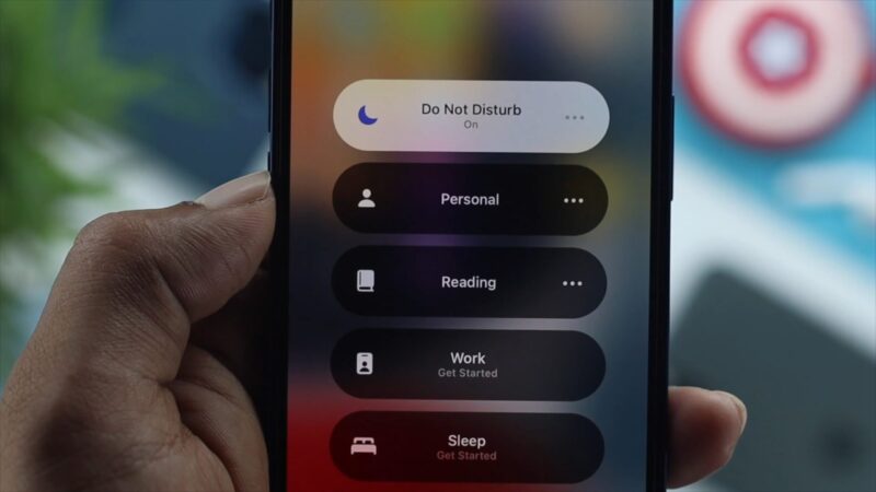 Close-up of an iPhone screen showing the "Do Not Disturb" settings menu with various focus modes like Personal, Reading, Work, and Sleep