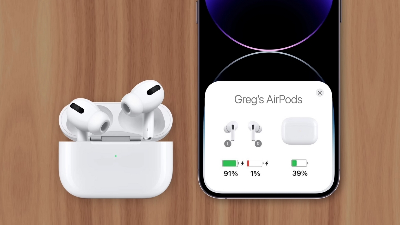 A Pair of AirPods Are in Their Charging Case, Displaying Battery Percentages on An iPhone Screen