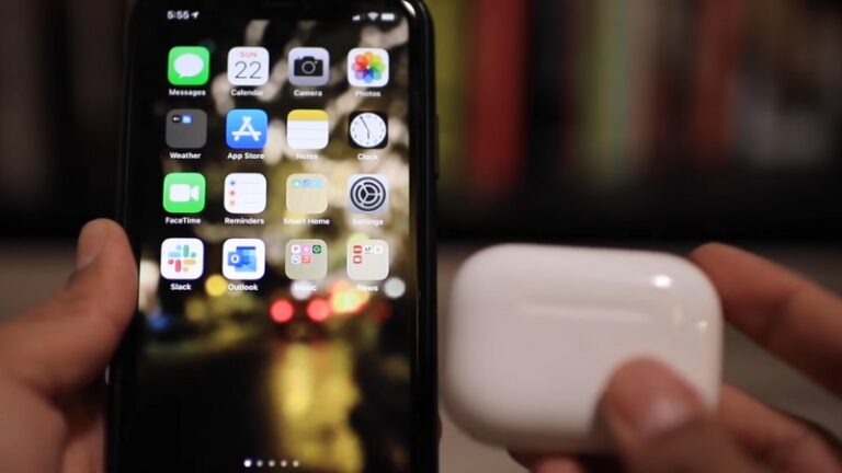 A Person Holding an AirPods Case Next to An iPhone, Trying to Connect the AirPods